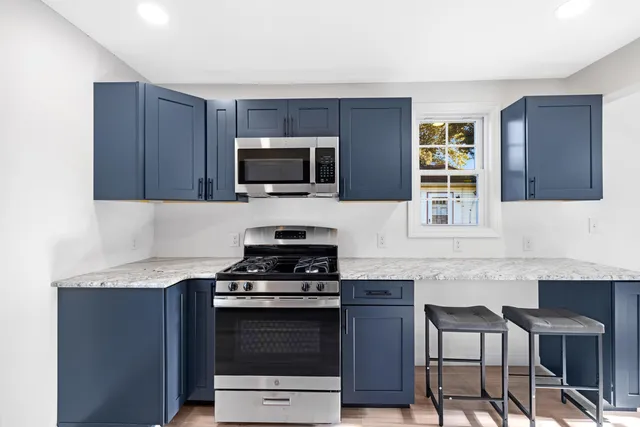 a kitchen with a refrigerator sink and cabinets