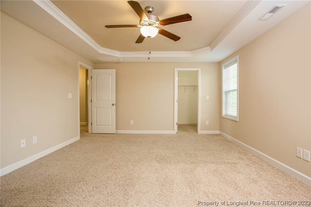 157 Shellbark Drive Spring Lake, NC 28390 - Photo 24 of 28 an empty room with chandelier fan and windows