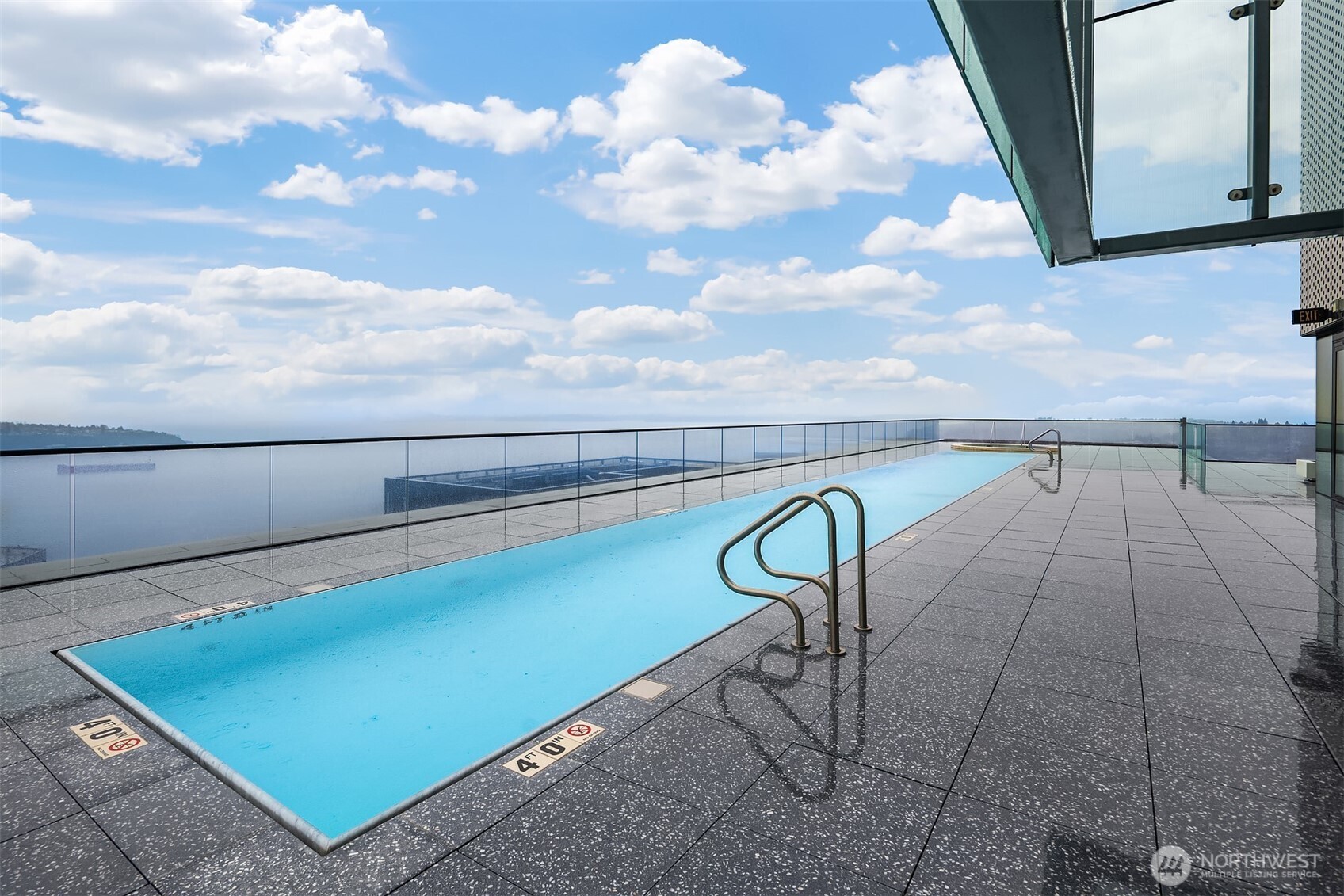 300 Virginia Street, Unit 3103 Seattle, WA 98101 - Photo 20 of 36 a view of a swimming pool with a lounge chair and a bookshelf