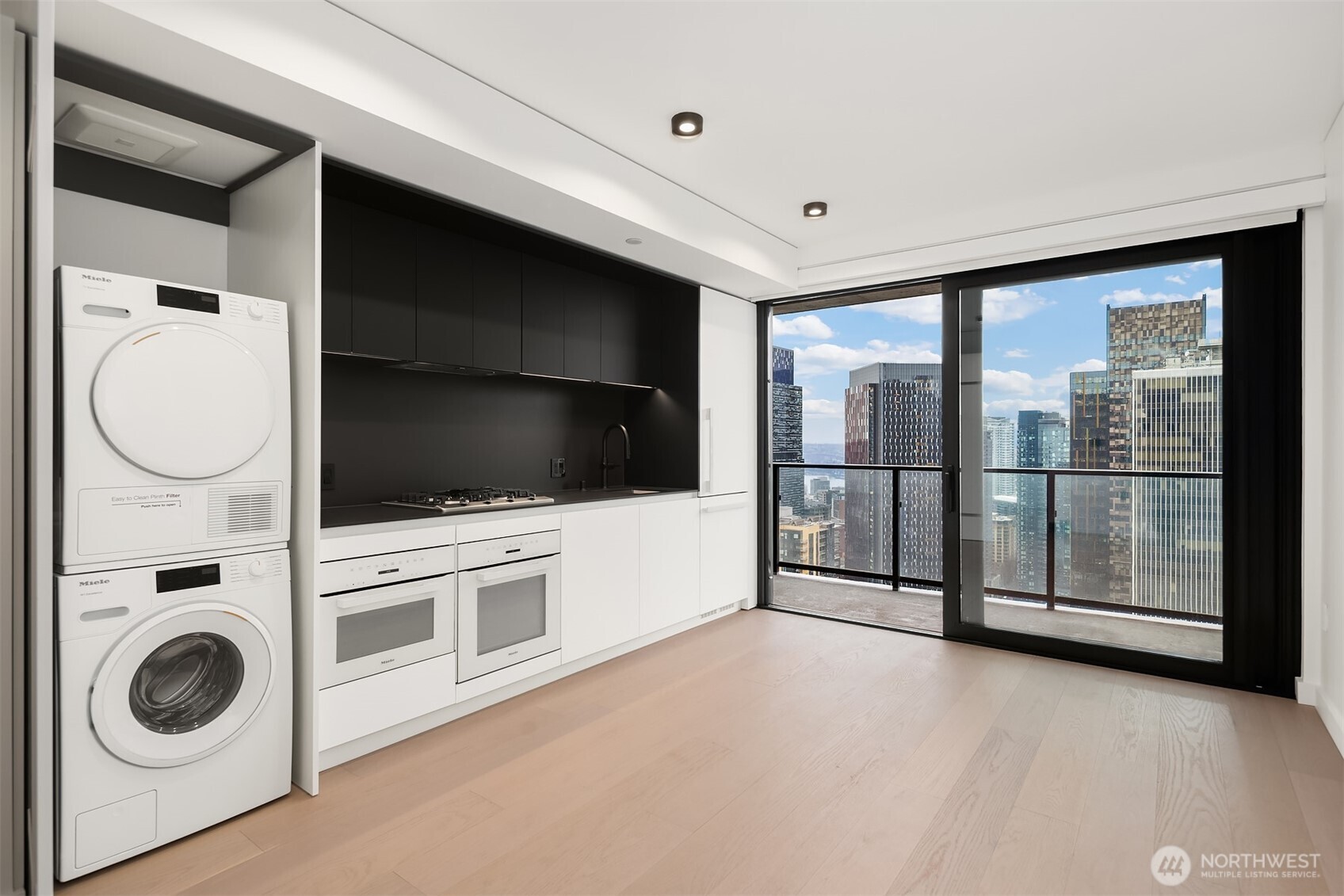 300 Virginia Street, Unit 3103 Seattle, WA 98101 - Photo 6 of 36 a view of a big room with entryway and wooden floor