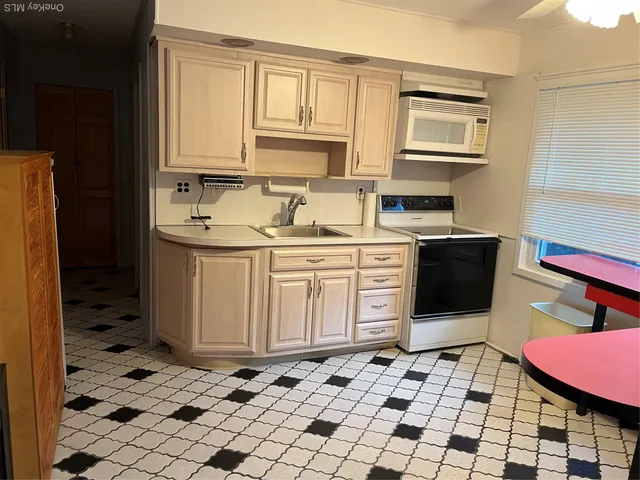 a kitchen with stainless steel appliances a sink and a refrigerator