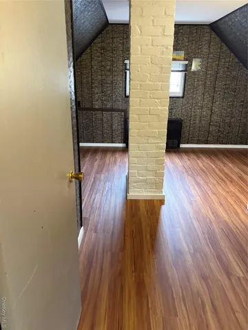 a view of wooden floor in an empty room