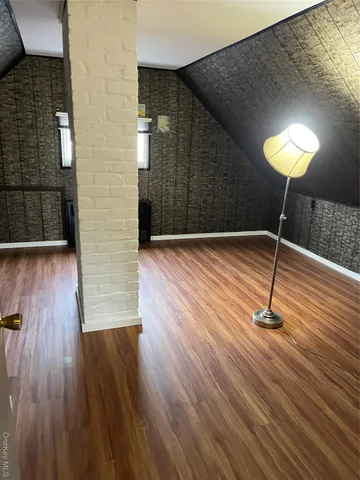 a view of wooden floor with a table in a wooden bench
