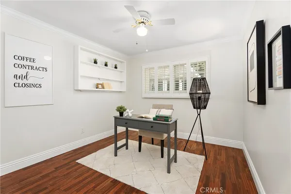 a view of a workspace with furniture window and wooden floor