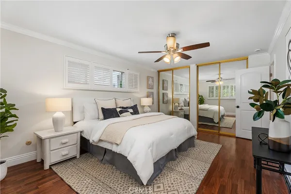 a bedroom with bed and wooden floor