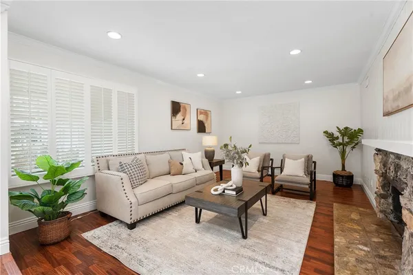 a living room with furniture potted plant and a window