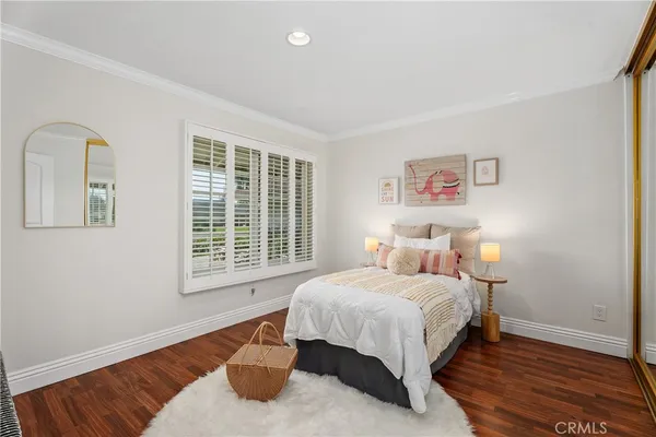 a bedroom with a bed lamp and a window