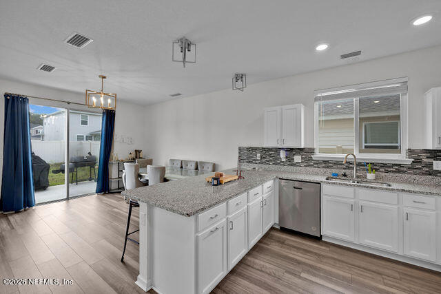 136 Peace River Road St. Johns, FL 32259 - Photo 13 of 40 a kitchen with stainless steel appliances granite countertop a sink stove and wooden cabinets