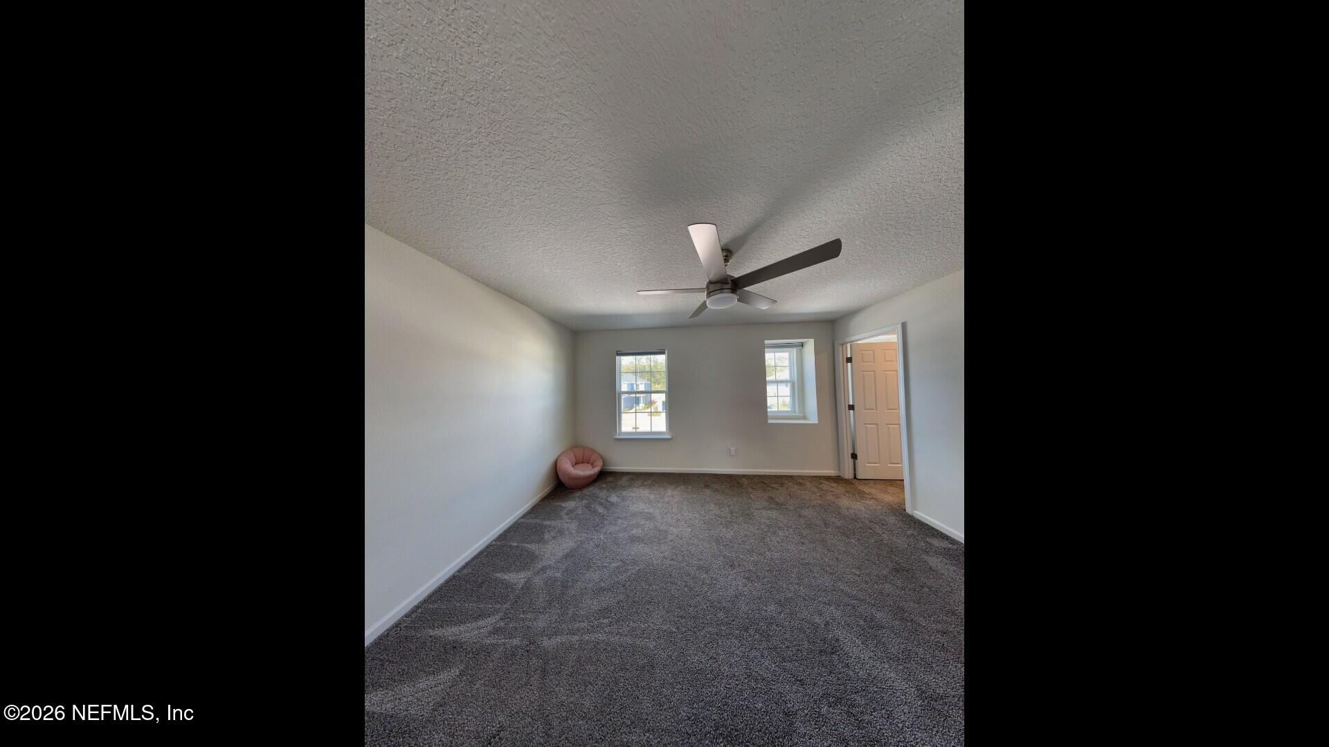 136 Peace River Road St. Johns, FL 32259 - Photo 20 of 40 a view of a big room with windows and a ceiling fan