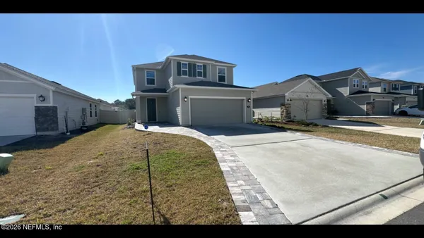 a view of a house with a white door and a yard