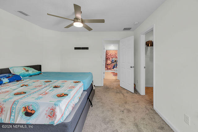 136 Peace River Road St. Johns, FL 32259 - Photo 27 of 40 a bedroom with a bed and a chandelier
