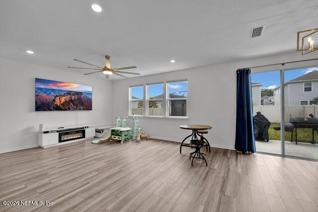 136 Peace River Road St. Johns, FL 32259 - Photo 39 of 40 a view of a livingroom with furniture a flat screen tv and wooden floor