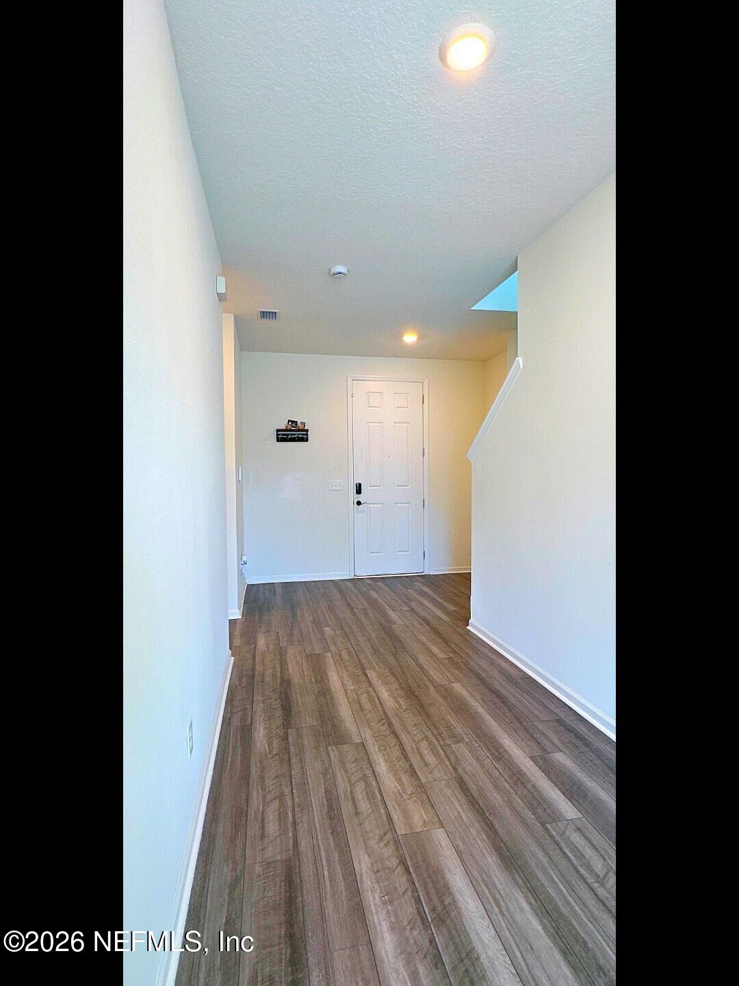 136 Peace River Road St. Johns, FL 32259 - Photo 6 of 40 a view of a room with wooden floor and white walls