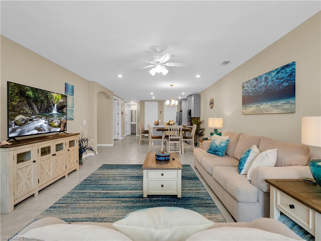 14695 Edgewater Circle Naples, FL 34114 - Photo 15 of 39 a living room with furniture and a flat screen tv