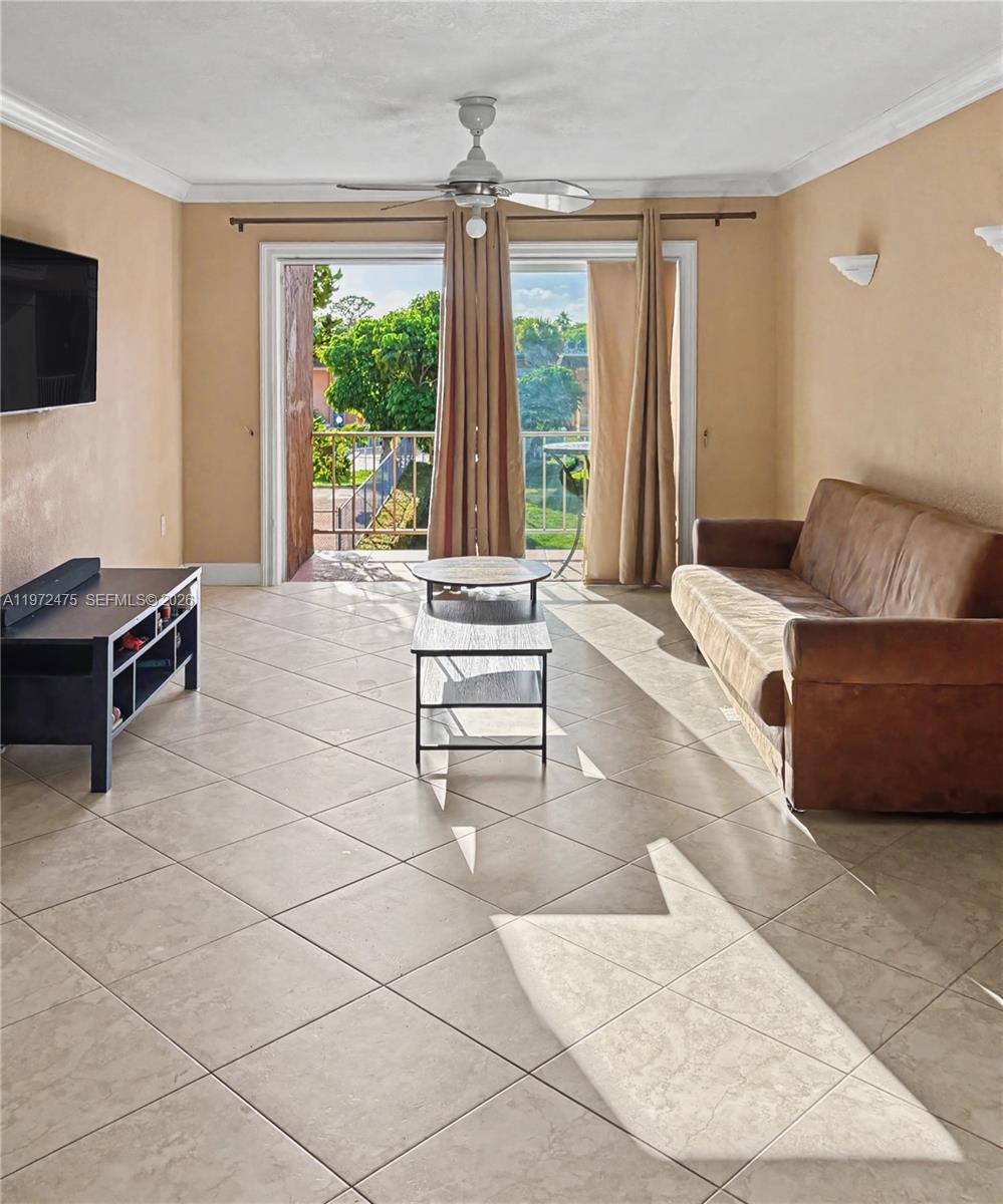 9417 Southwest 76th Street, Unit X36 Miami, FL 33173 - Photo 2 of 10 a living room with furniture and a flat screen tv