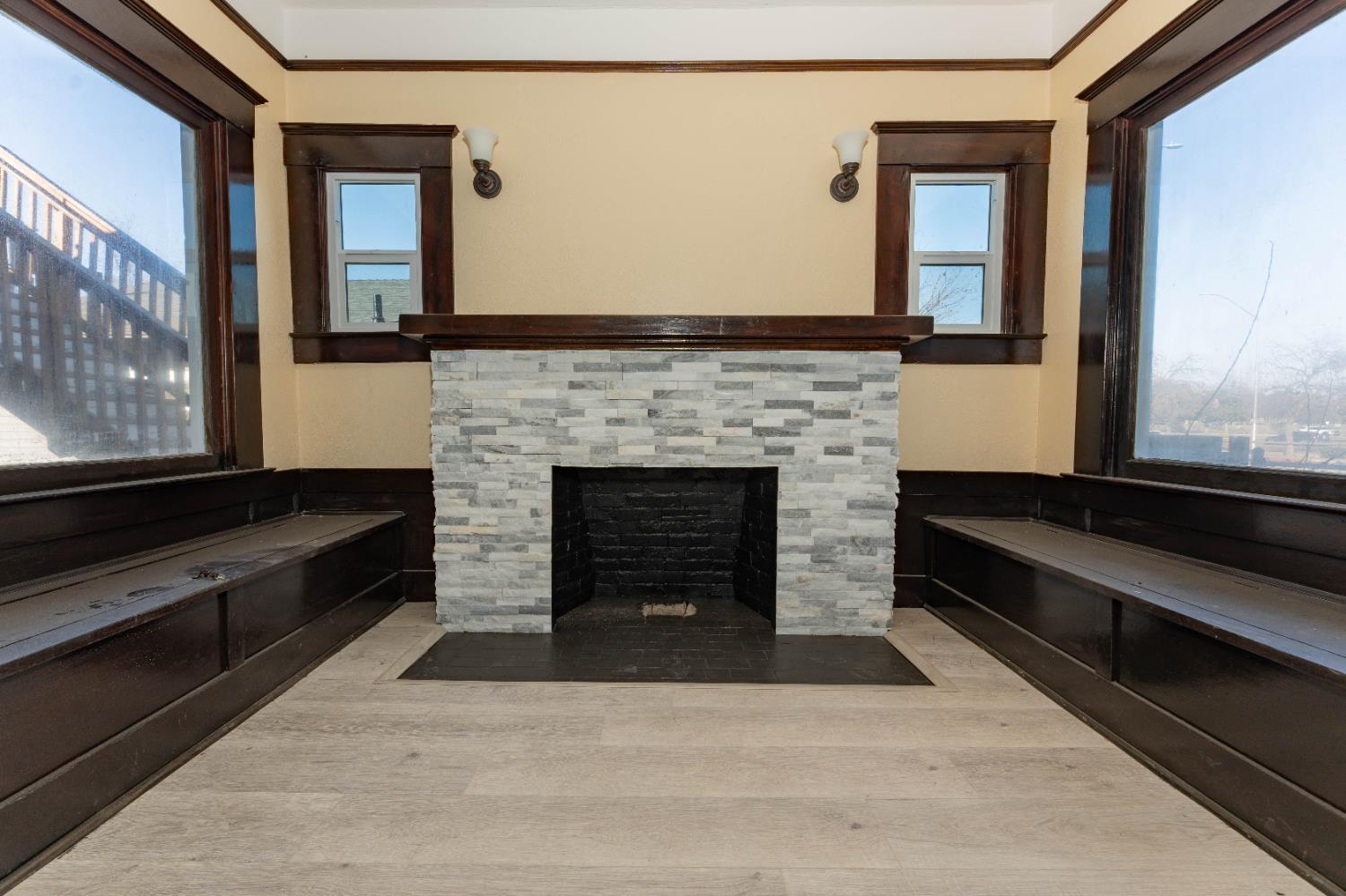 4354 East Kings Canyon Road Fresno, CA 93702 - Photo 11 of 70 a living room with a fireplace and a large window