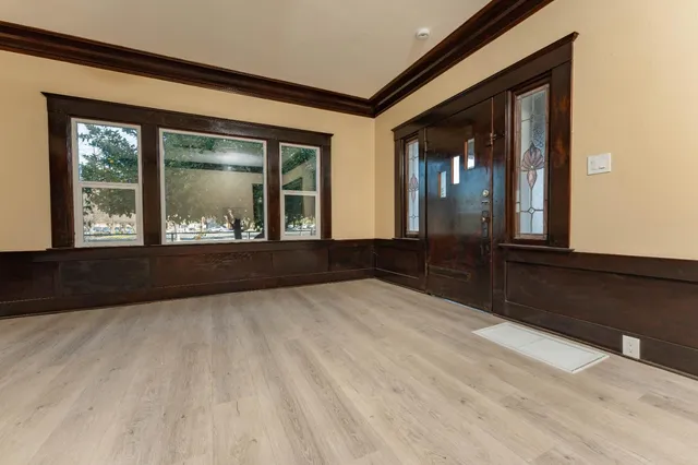 an empty room with windows and closet