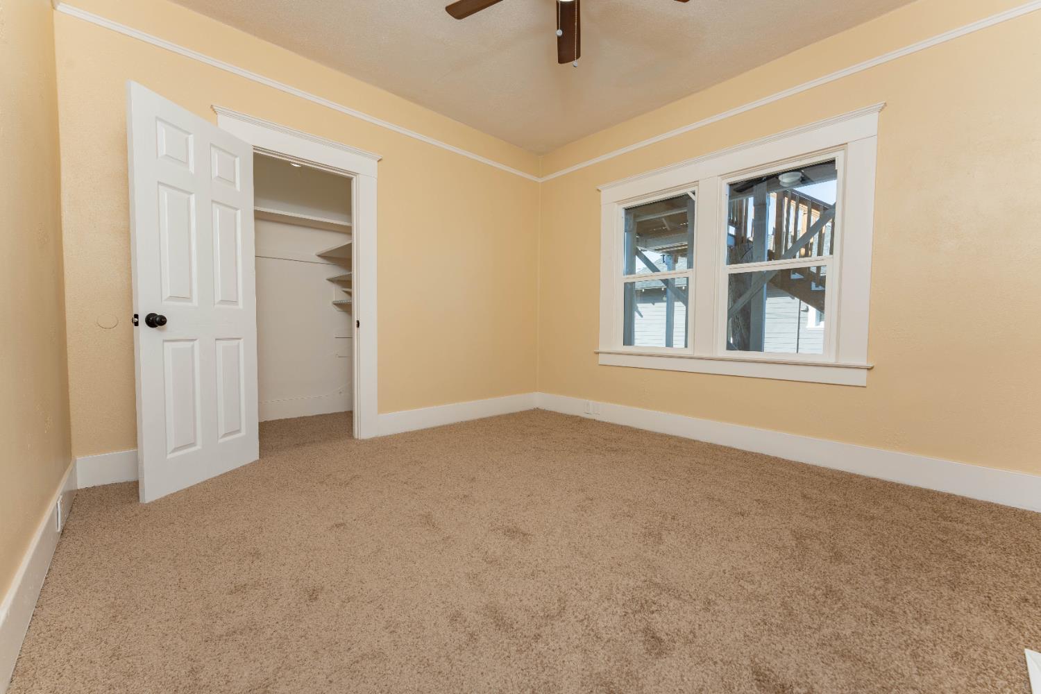 4354 East Kings Canyon Road Fresno, CA 93702 - Photo 19 of 70 an empty room with windows and closet