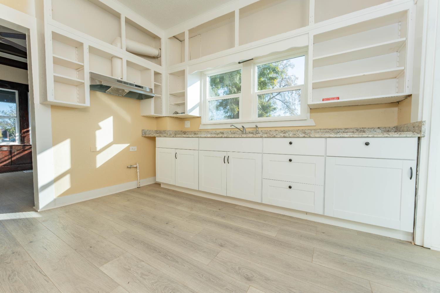 4354 East Kings Canyon Road Fresno, CA 93702 - Photo 22 of 70 a view of a kitchen with granite countertop cabinets and window