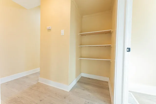 a view of a kitchen with wooden floor