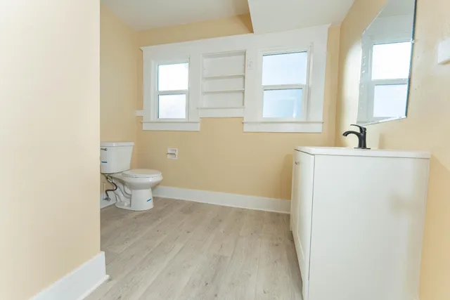 a view of a kitchen with white cabinets