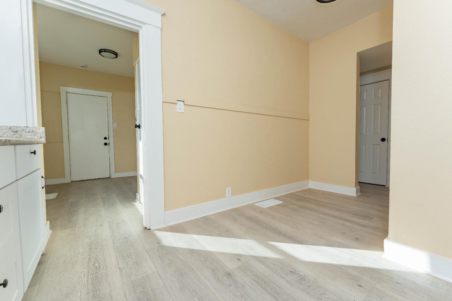 4354 East Kings Canyon Road Fresno, CA 93702 - Photo 27 of 70 a view of an empty room with wooden floor