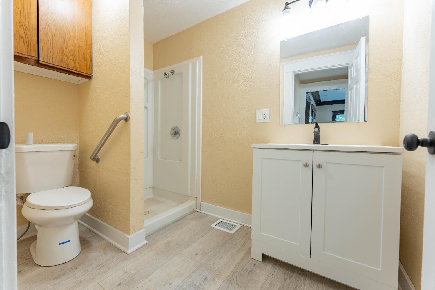 4354 East Kings Canyon Road Fresno, CA 93702 - Photo 30 of 70 a bathroom with a toilet sink and a mirror