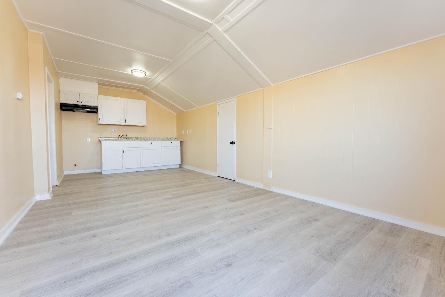 4354 East Kings Canyon Road Fresno, CA 93702 - Photo 36 of 70 a view of a kitchen with wooden floor