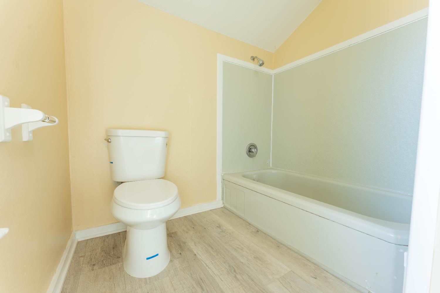 4354 East Kings Canyon Road Fresno, CA 93702 - Photo 41 of 70 a bathroom with a toilet sink and bathtub