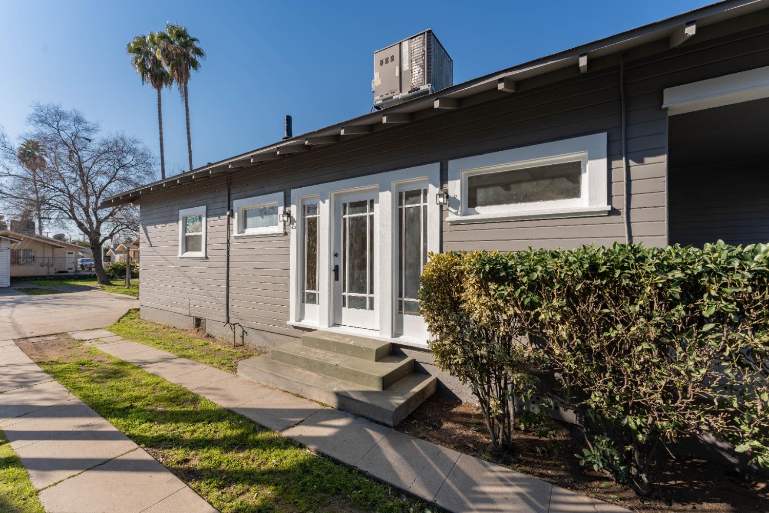 4354 East Kings Canyon Road Fresno, CA 93702 - Photo 52 of 70 a front view of a house with a yard