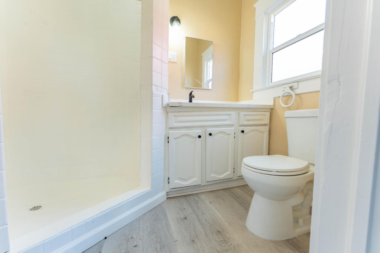 4354 East Kings Canyon Road Fresno, CA 93702 - Photo 57 of 70 a bathroom with a toilet sink and mirror