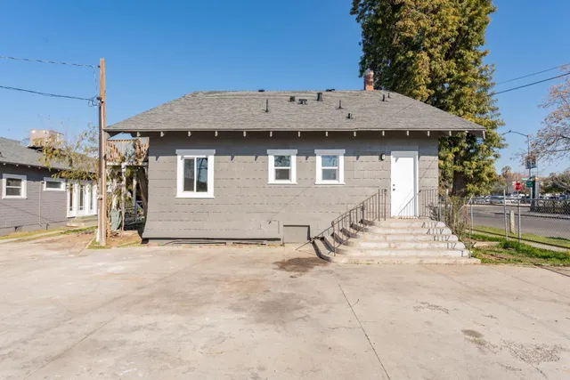 a view of a house with a yard covered with snow in the road