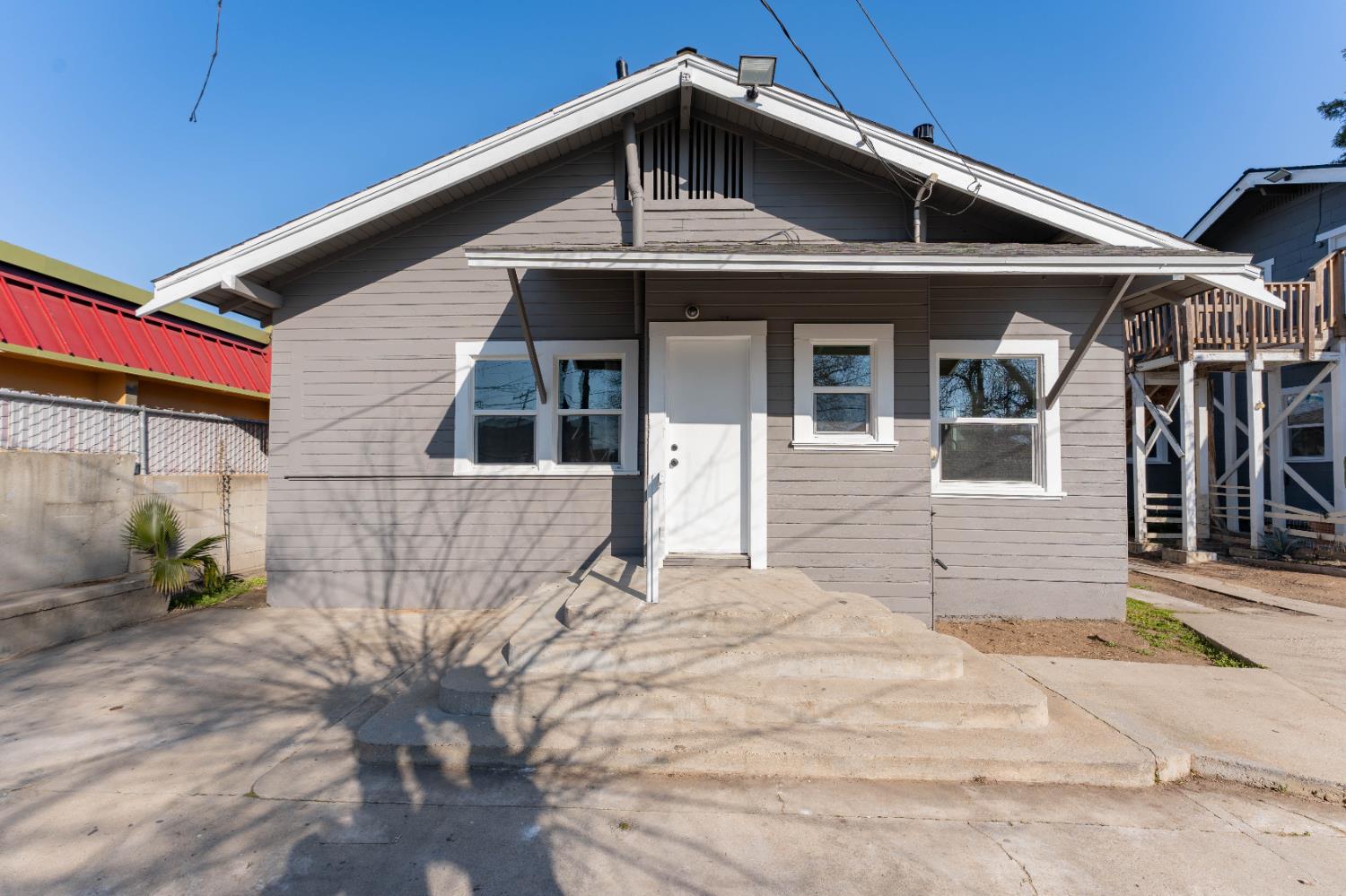 4354 East Kings Canyon Road Fresno, CA 93702 - Photo 70 of 70 a front view of a house with a yard