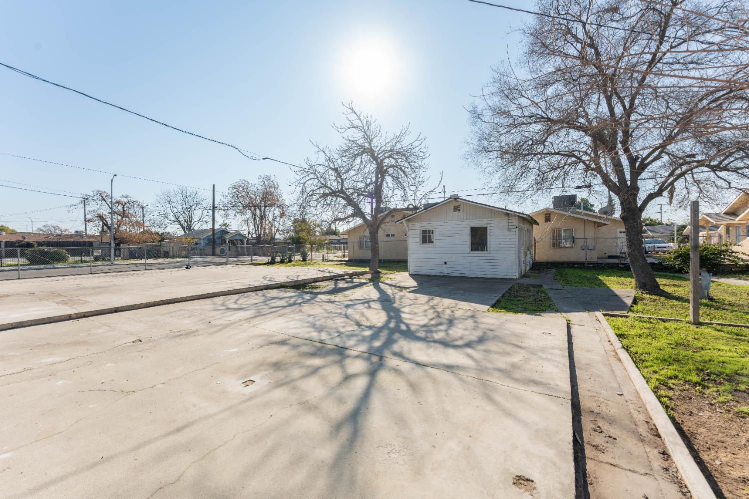 4354 East Kings Canyon Road Fresno, CA 93702 - Photo 8 of 70 a view of a house with a yard covered with snow in the road