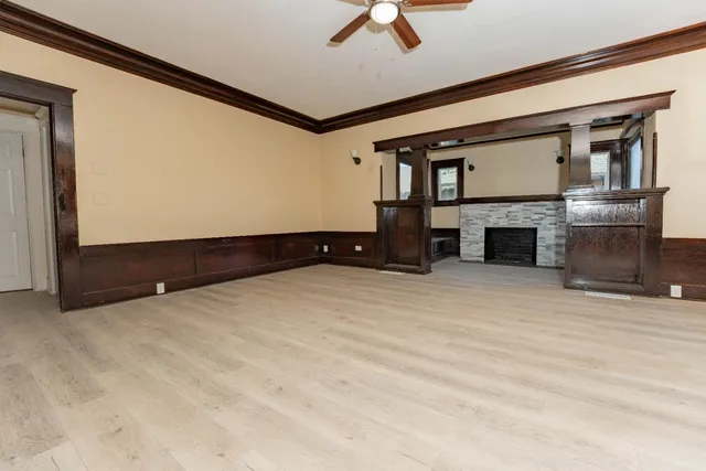 a living room with a fireplace and a large window