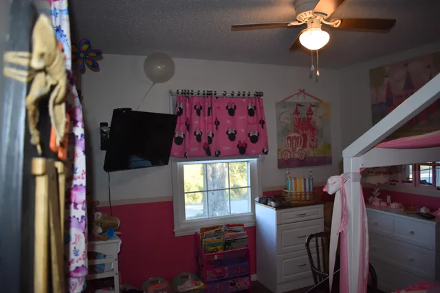 a view of a workspace with furniture and a flat screen tv