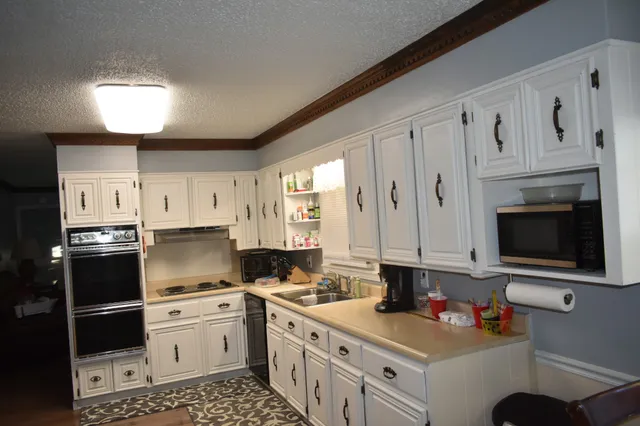 a kitchen with stainless steel appliances a stove a sink and a refrigerator