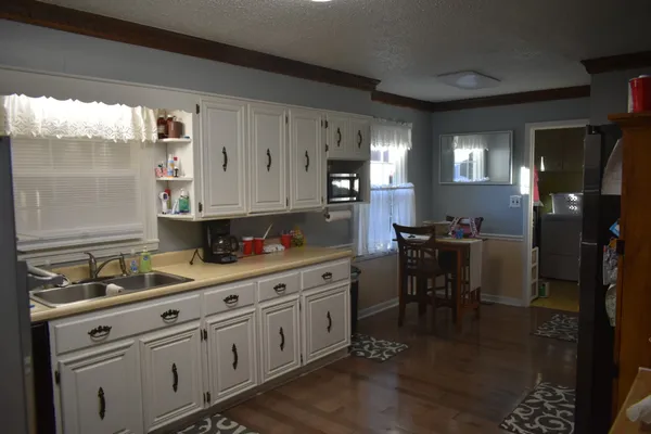 a kitchen with granite countertop cabinets and white appliances