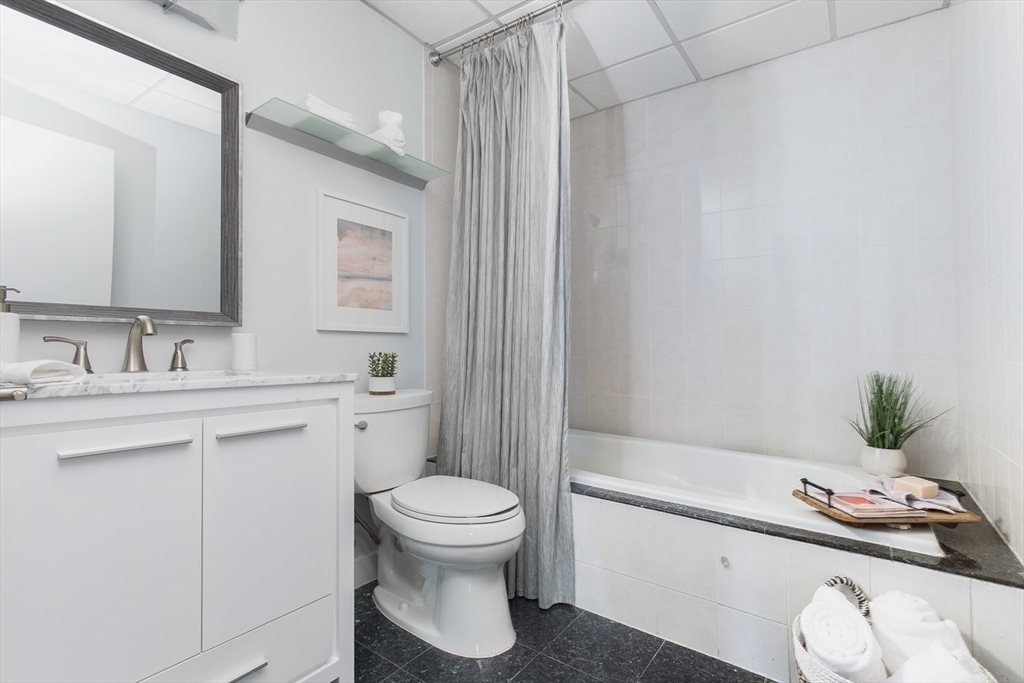 10 Williams Street, Unit 13 Boston, MA 02119 - Photo 12 of 38 a bathroom with a sink a toilet and shower