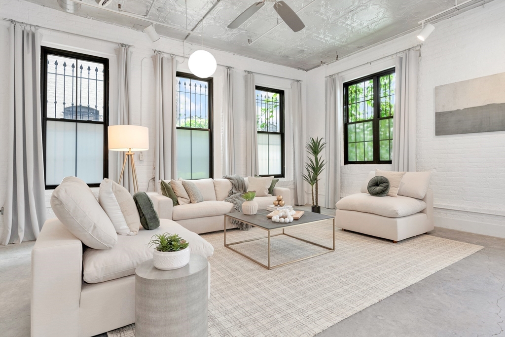 10 Williams Street, Unit 13 Boston, MA 02119 - Photo 2 of 38 a living room with furniture and a large window
