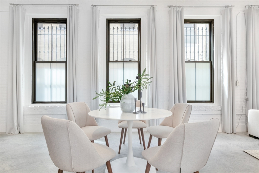 10 Williams Street, Unit 13 Boston, MA 02119 - Photo 26 of 38 a dining room with furniture and windows