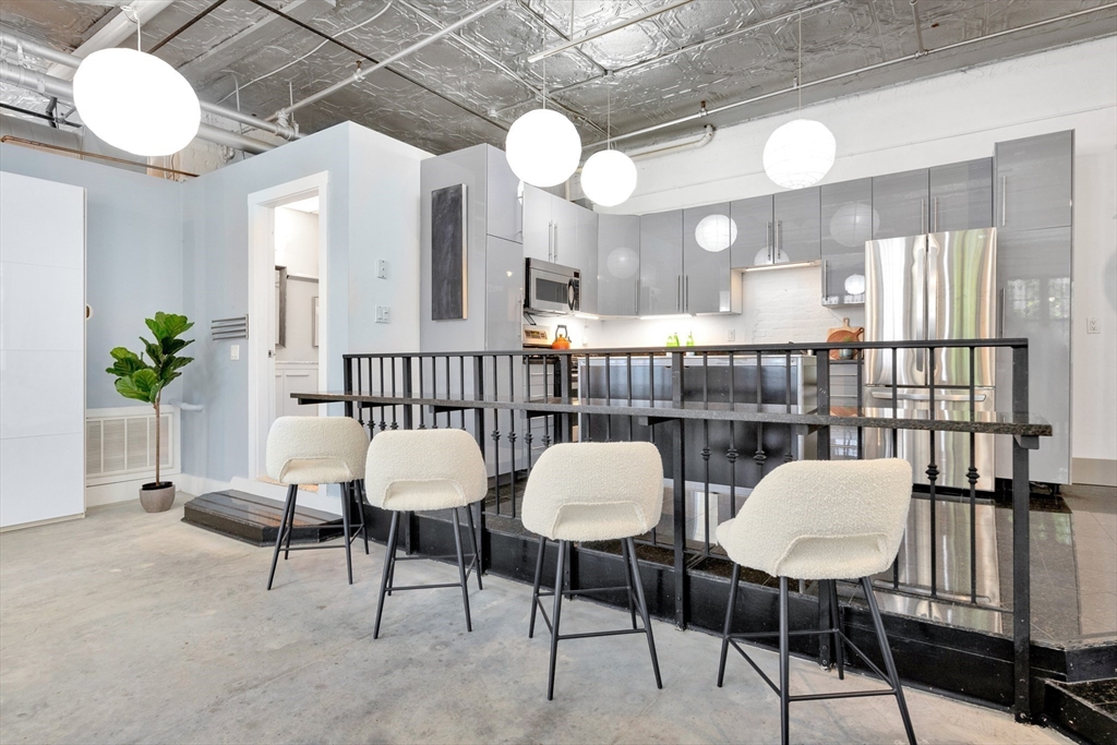 10 Williams Street, Unit 13 Boston, MA 02119 - Photo 28 of 38 a view of a dining room with furniture and a chandelier