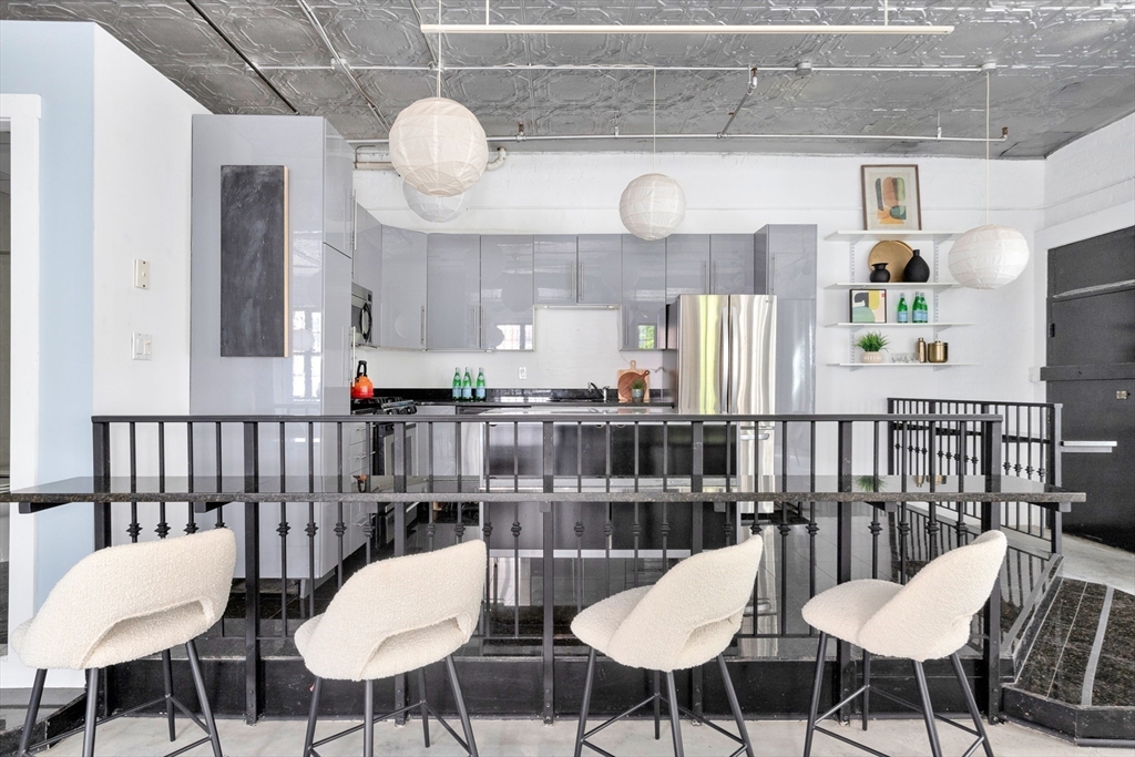 10 Williams Street, Unit 13 Boston, MA 02119 - Photo 29 of 38 a view of a dining room with furniture and wooden floor