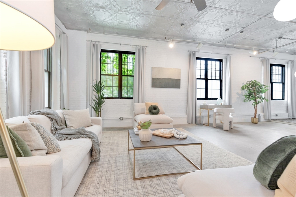10 Williams Street, Unit 13 Boston, MA 02119 - Photo 3 of 38 a living room with furniture and a large window
