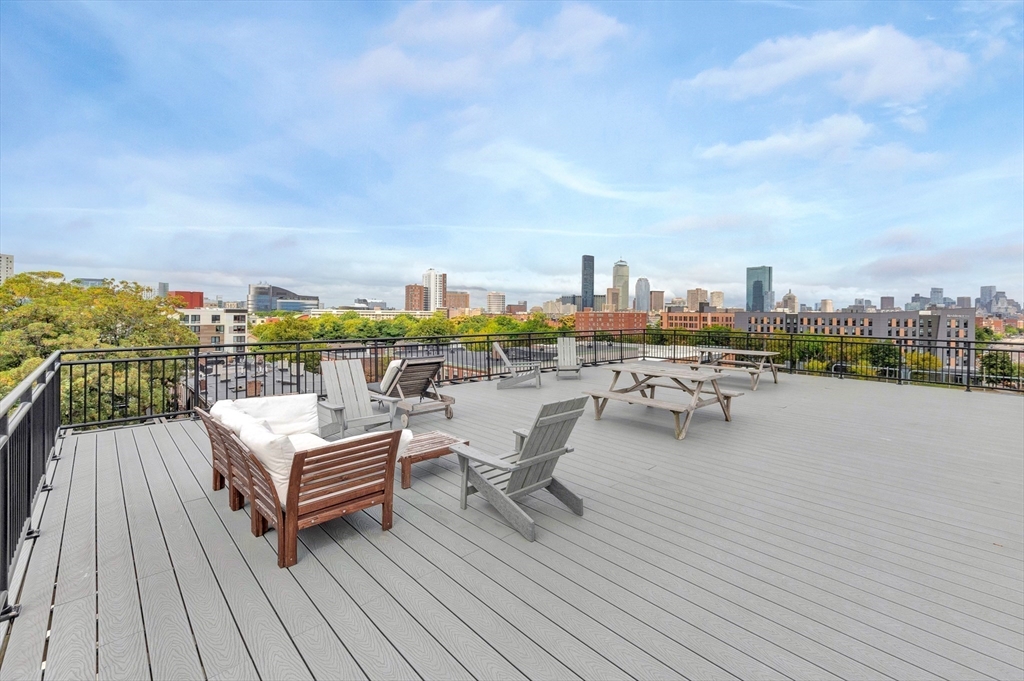 10 Williams Street, Unit 13 Boston, MA 02119 - Photo 33 of 38 a view of roof deck with seating area and city view