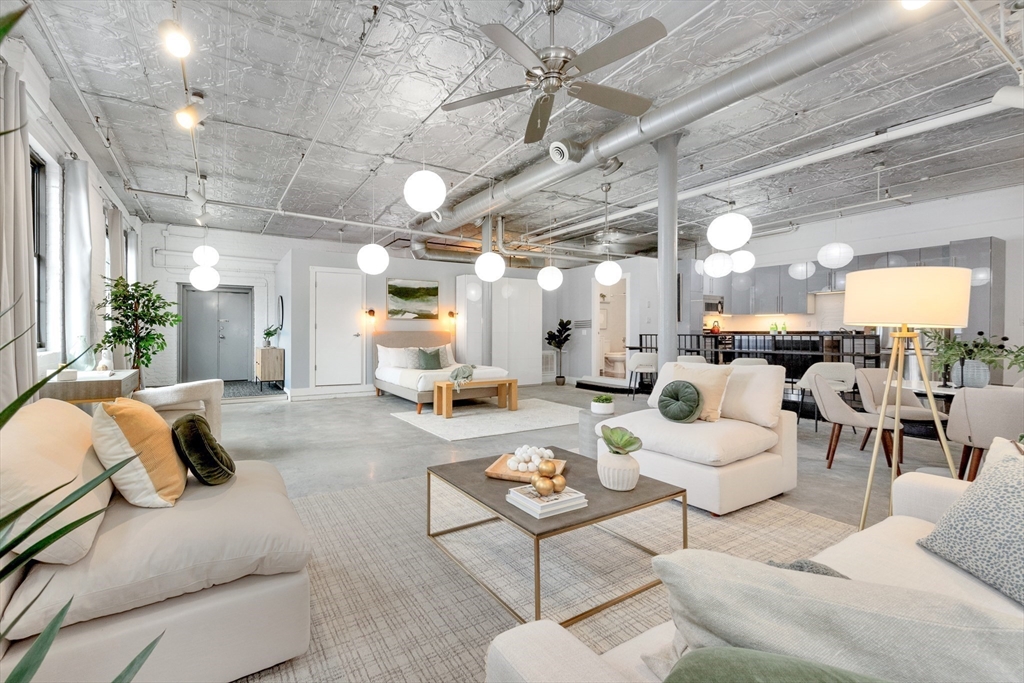 10 Williams Street, Unit 13 Boston, MA 02119 - Photo 4 of 38 a living room with furniture and a chandelier