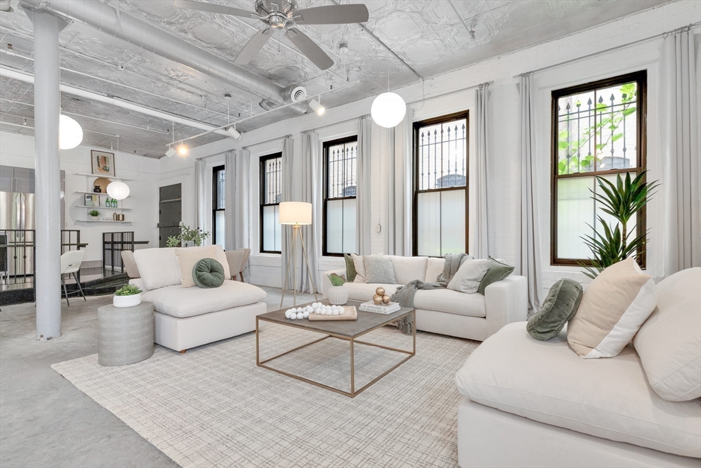10 Williams Street, Unit 13 Boston, MA 02119 - Photo 6 of 38 a living room with furniture and a large window
