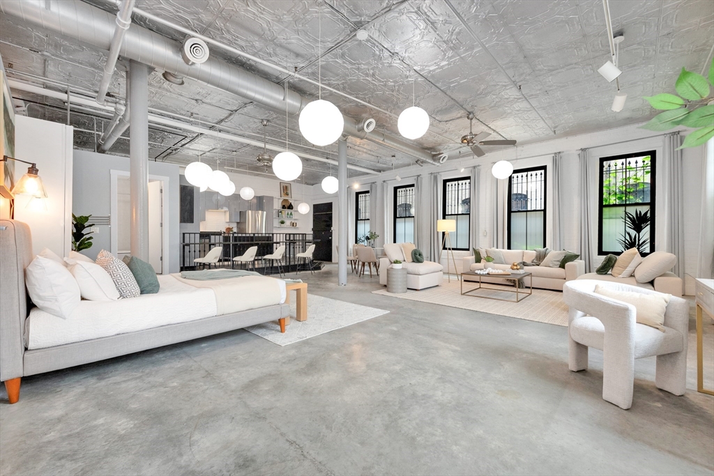 10 Williams Street, Unit 13 Boston, MA 02119 - Photo 10 of 38 a living room with furniture and white walls