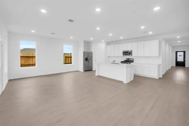 a view of a kitchen with a sink and a refrigerator