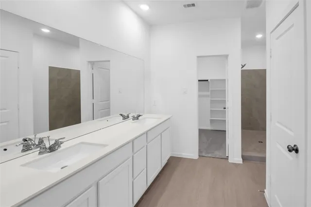 a bathroom with a double vanity sink and mirror